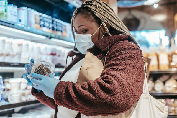 Shopper reading a gluten-free pasta label to verify its FSSAI certification before buying