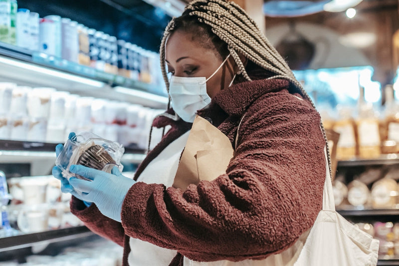 Shopper reading a gluten-free pasta label to verify its FSSAI certification before buying