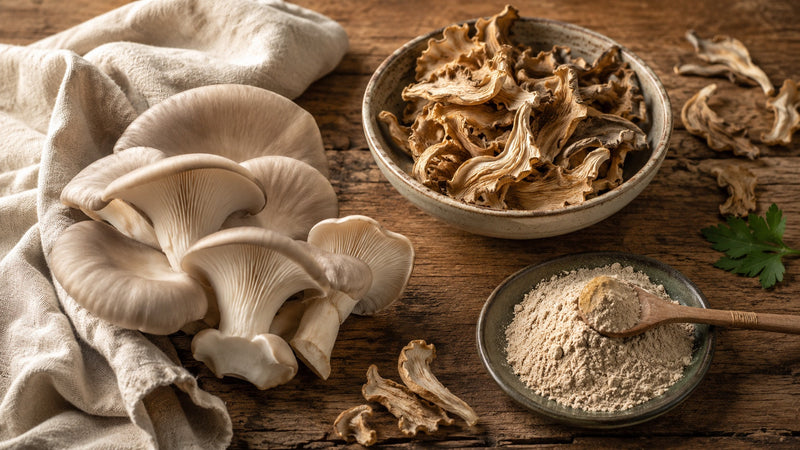 Fresh oyster mushrooms, dried oyster mushroom pieces, and oyster mushroom powder compared side by side on a wooden surface