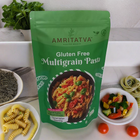 Amritatva gluten-free multigrain pasta package on a table with pasta and ingredients.