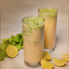 Amritatva Sattu Protein Mix served in tall glasses with fresh herbs and lemon — plant-based protein drink India
