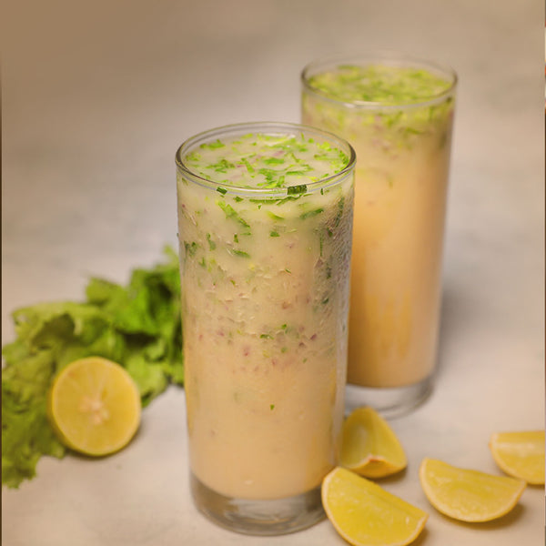 Amritatva Sattu Protein Mix served in tall glasses with fresh herbs and lemon — plant-based protein drink India